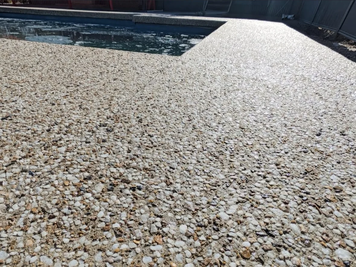 Close view of the Two Wells exposed aggregate finish beside the pool